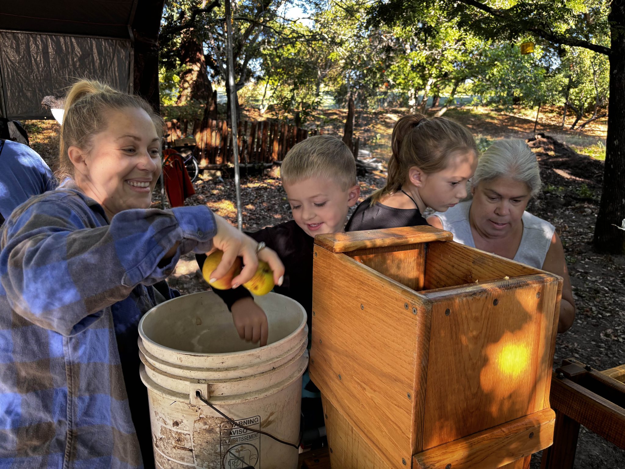 Two men using the apple press